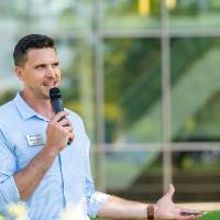 Director of Alumni Relations, Mike Przydzial, speaking into a microphone